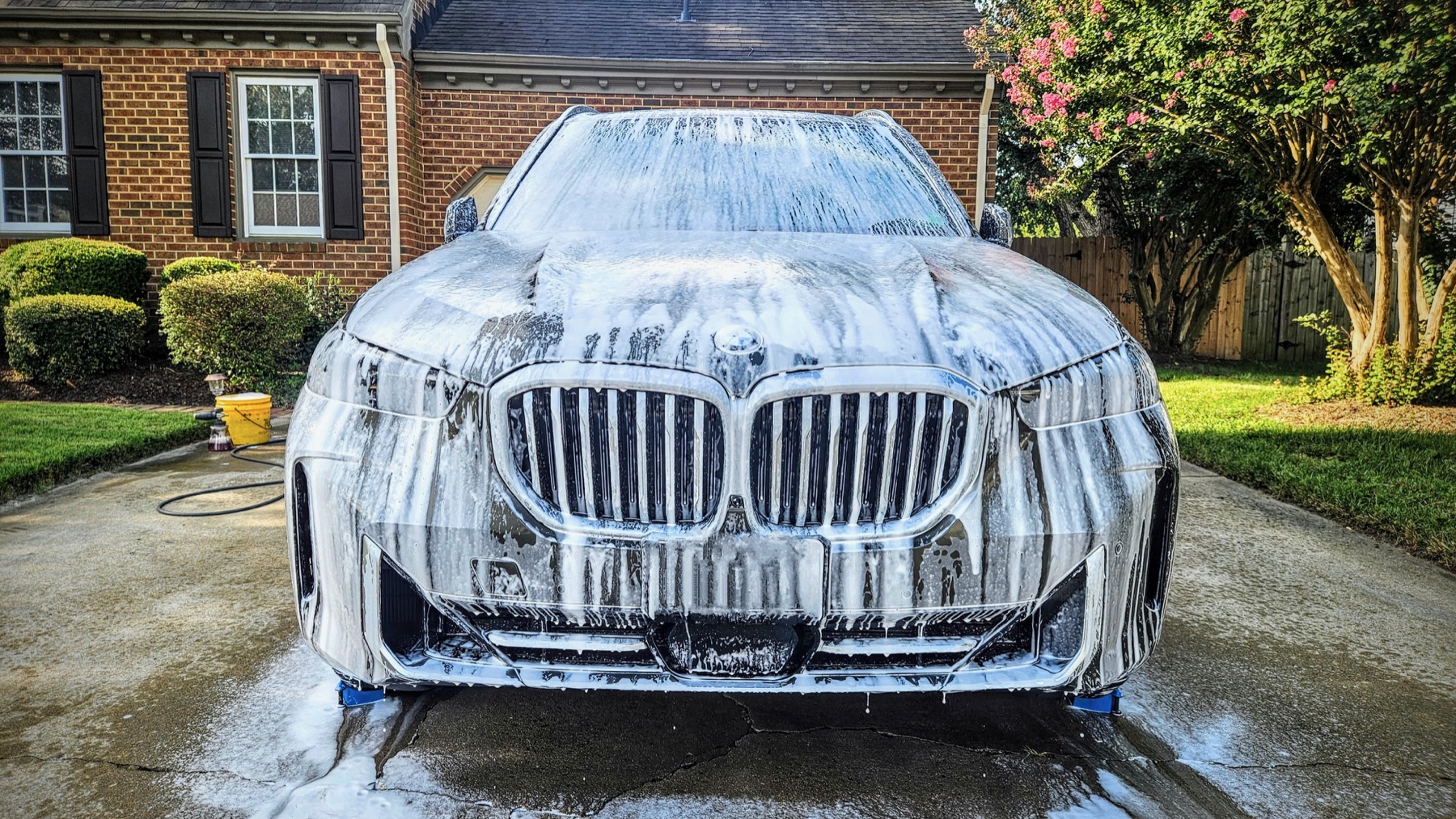 BMW covered in foam during a mobile wash